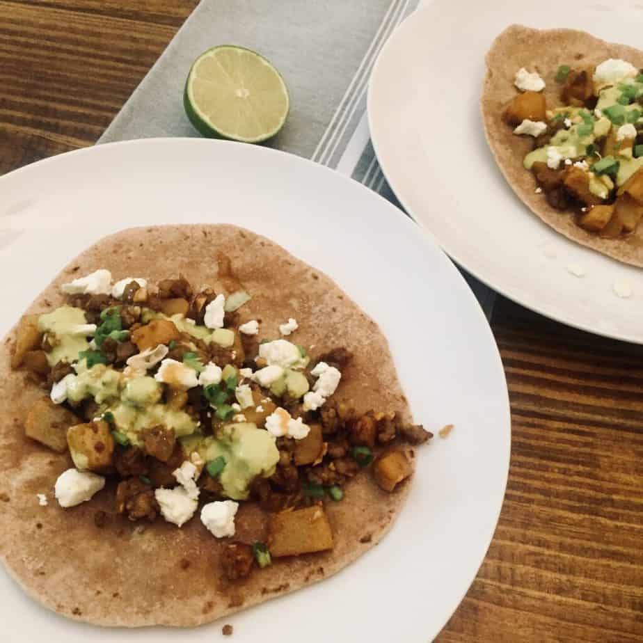 Sausage Potato tacos are so cheap, easy and delicious. Top with feta, green onions, cilantro, TJ's jalapeno sauce and Cholula.