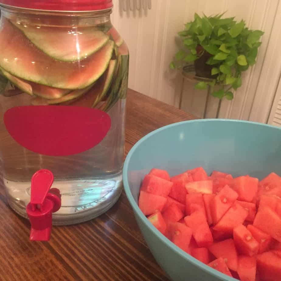 Watermelon salad starts with peeling and cubing a watermelon. Don't toss the peels! Use them to infuse a big jug of water