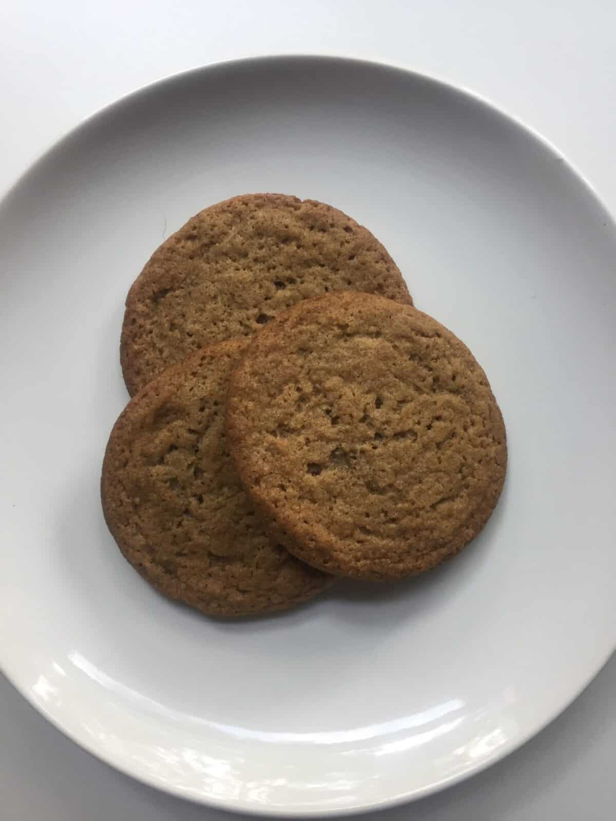 3 pecan butter cookies on a white plate.