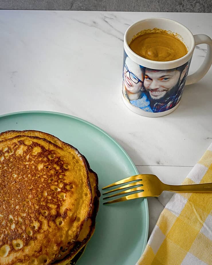 My healthy banana pancakes on a turquoise plate with a yellow ginham napkin and a mug full of dalgona coffee