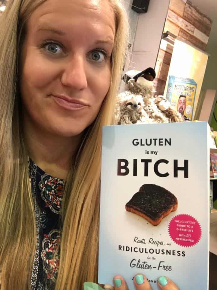 My beautiful and hilarious cousin Jenn holding a copy of the book "Gluten is my Bitch" after her celiac diagnosis.
