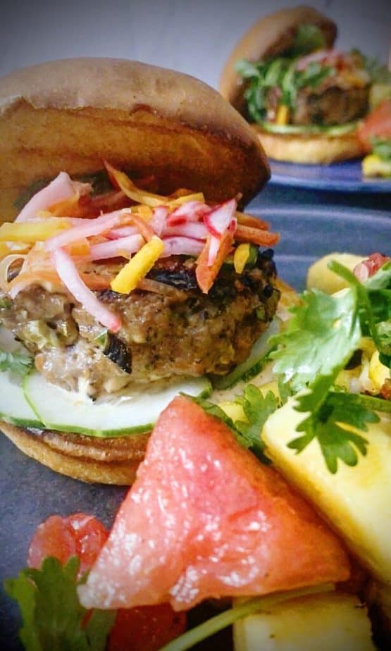 Close up shot of banh mi pork burger with spicy pineapple and watermelon salad
