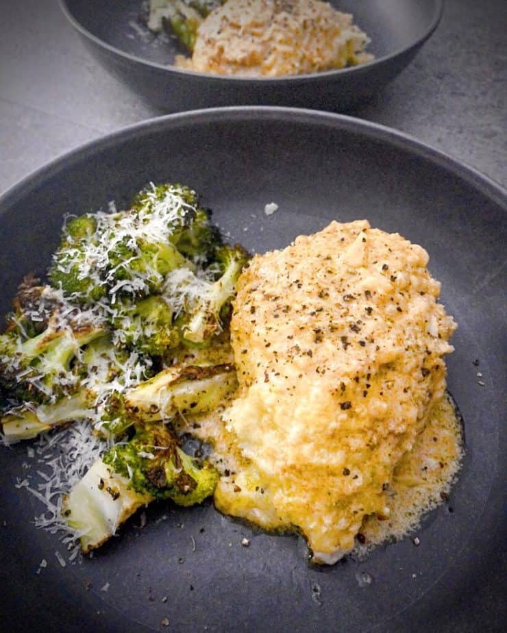 Close up shot of Crispy Parmesan Baked Chicken with Roasted Broccoli and Pan Sauce