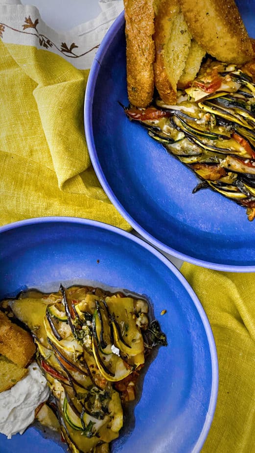 Ratatouille is harder to plate prettily than it is to assemble in the cast iron. This is my attempt to make pretty slices of it like a pizza, served with goat cheese and toast points in blue pasta bowls with yellow napkins.