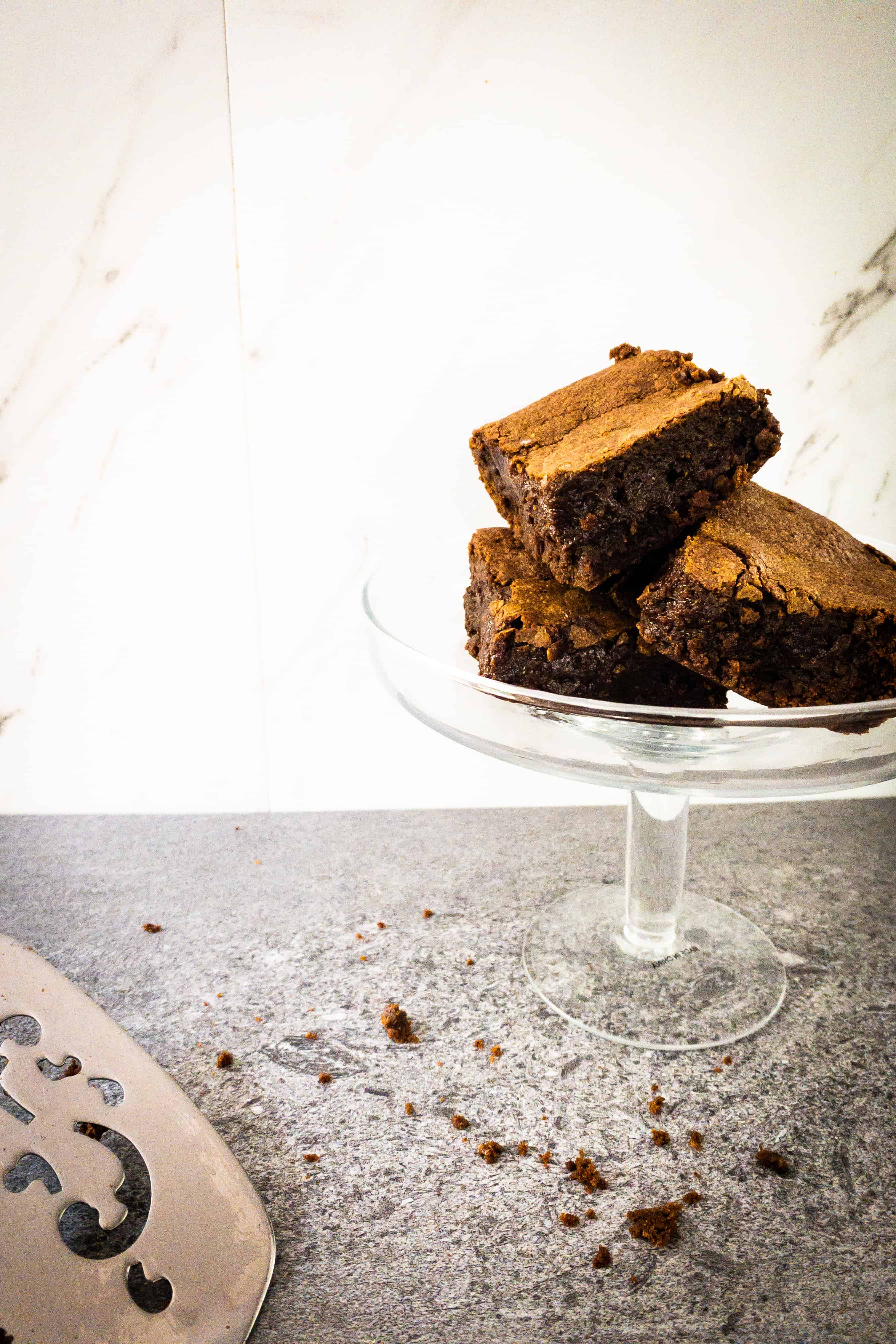 A raised cake plate piled high with Julia Child's brownies 