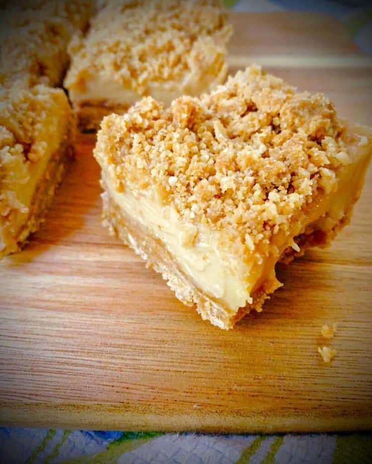 up close shot of key lime dessert bar with coconut ginger crumble topping