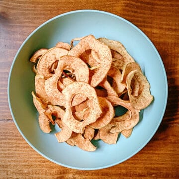turquoise bowl of dehydrated apple chips.