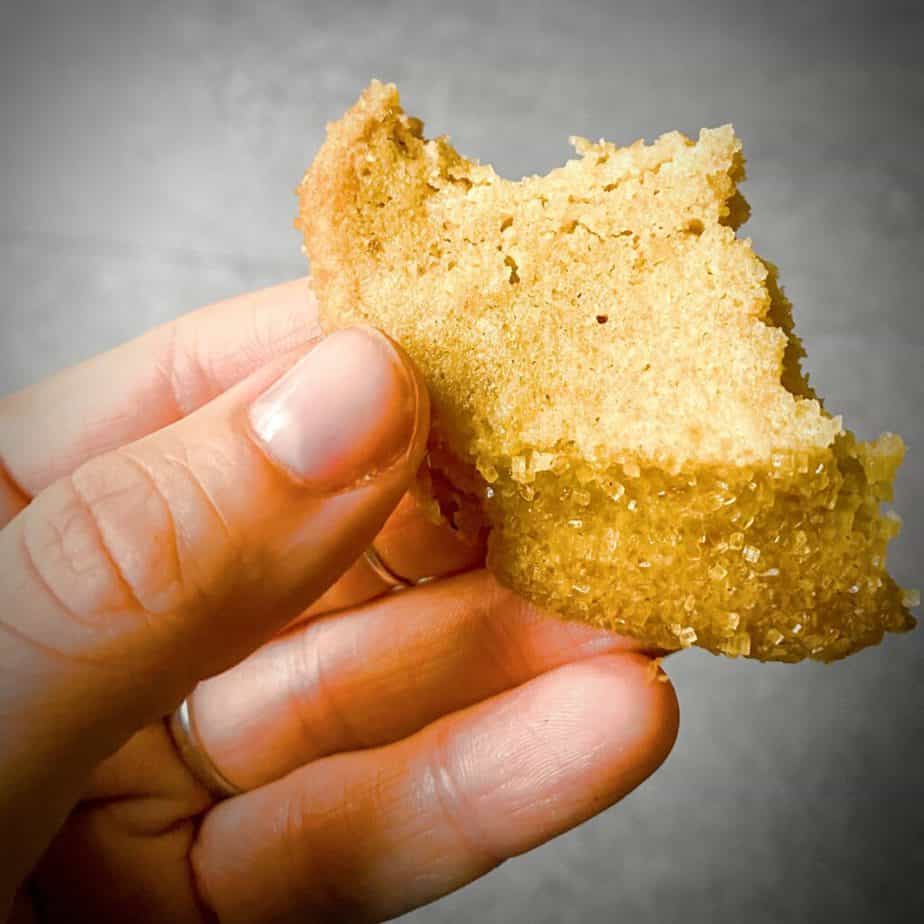hand holding a half eaten brown sugar brown butter shortbread cookie