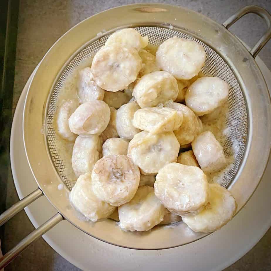 steeped bananas that have been removed from milk using a mesh strainer