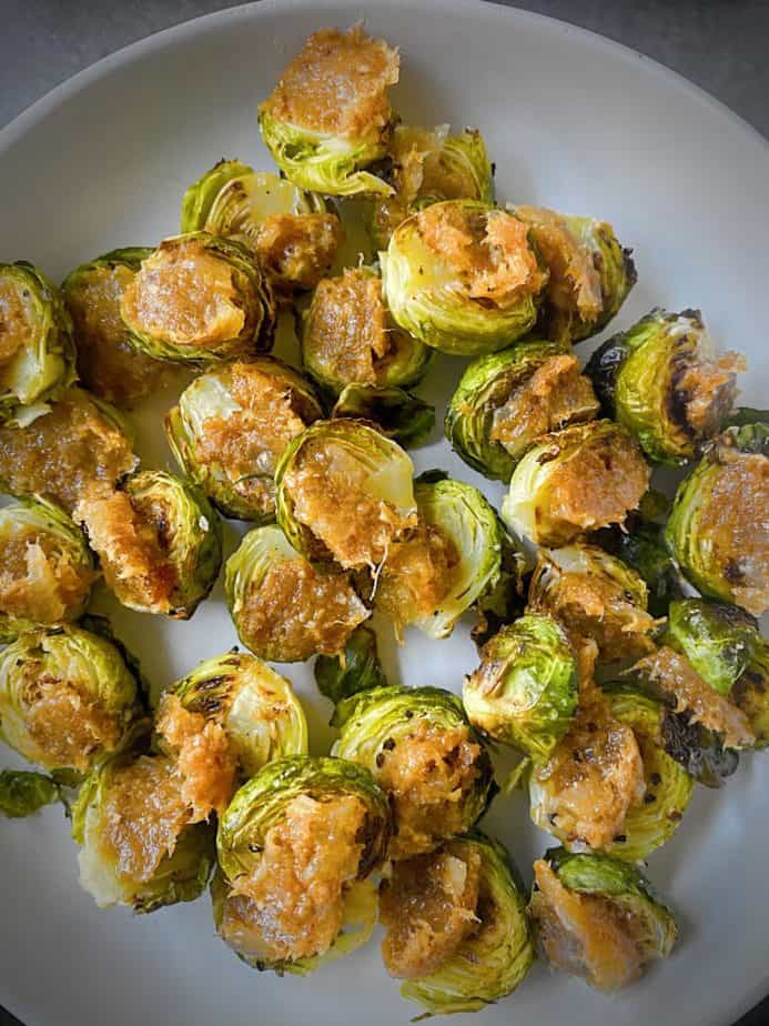 Roasted brussels sprouts with bacon jam on grey pasta plate