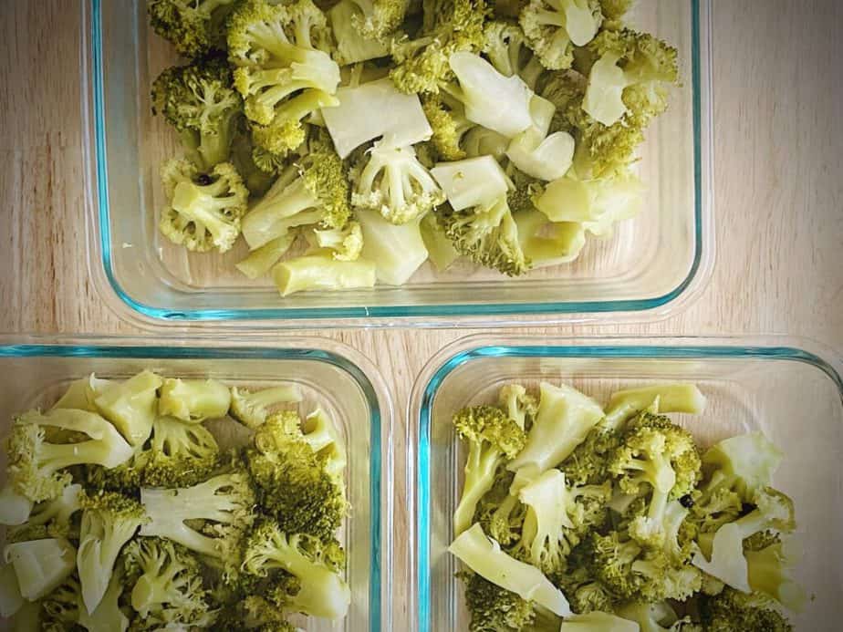 broccoli in the bottom of a trio of small casserole dishes