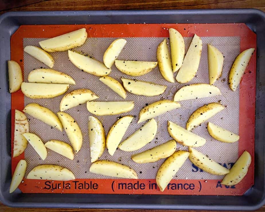 simply seasoned potato wedges on a silpat lined baking sheet prior to baking
