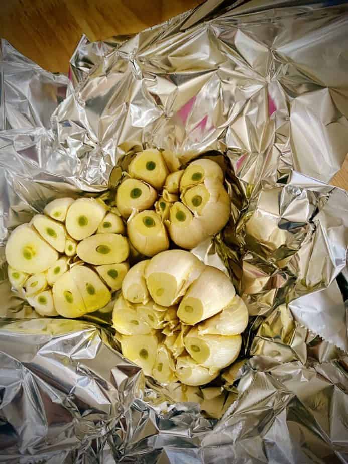 olive oil topped garlic in foil for roasting