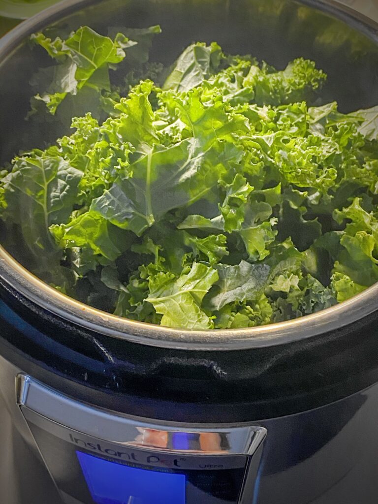 3-4 handfuls of chopped kale added to navy bean soup in instant pot
