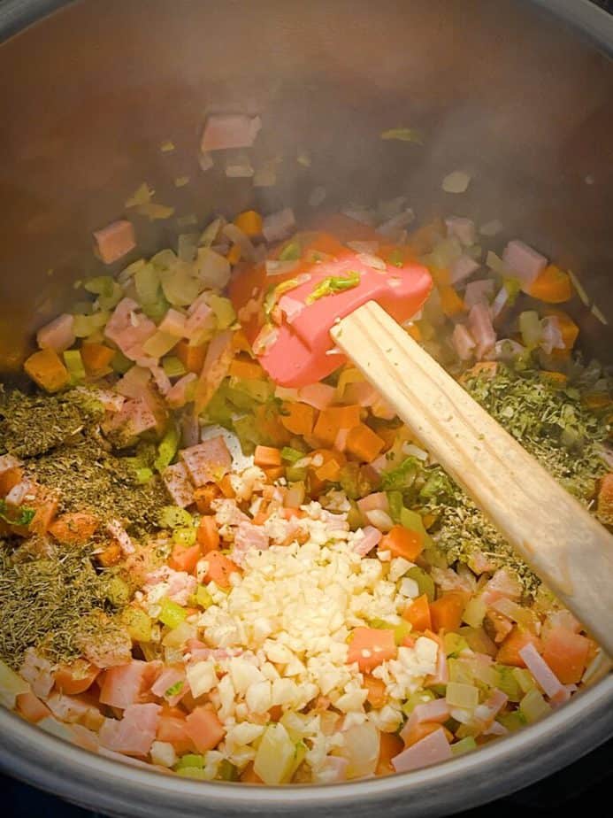 garlic and herbs added to mirepoix and ham mix in instant pot