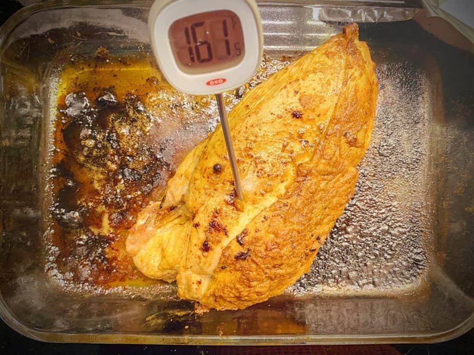 tandoori roasted turkey breast in 9 x 13 with meat thermometer registering 161.5F