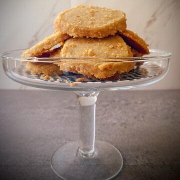 Small cake stand filled with brown sugar brown butter shortbread cookies.