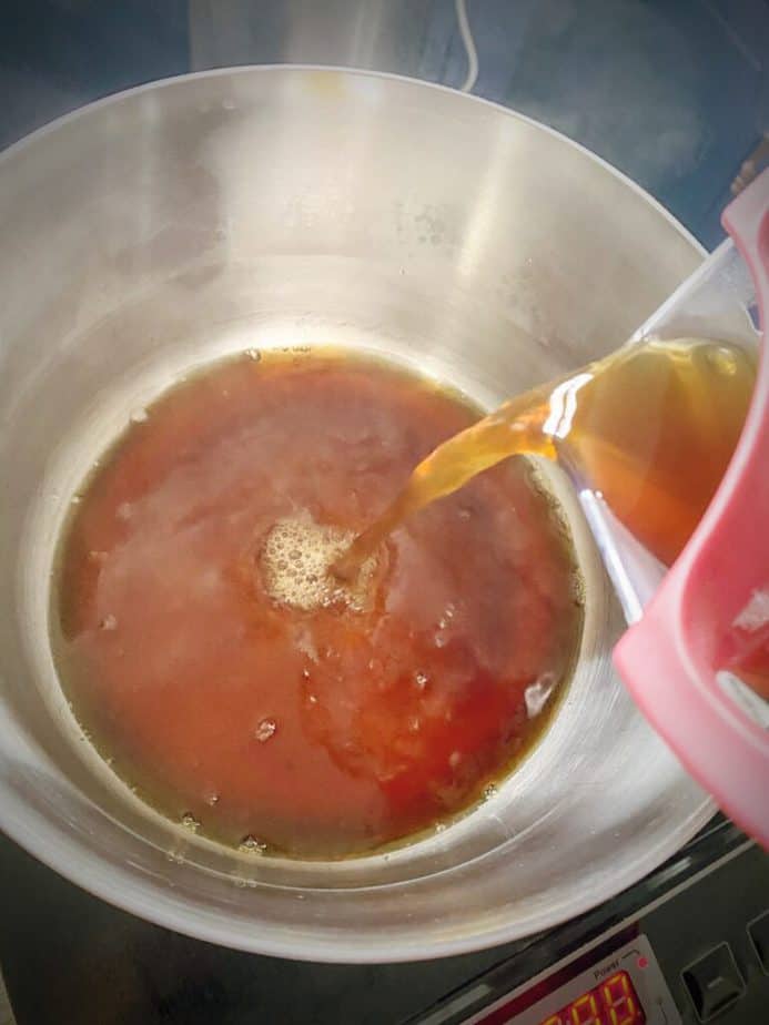 hot coffee getting poured into a saucepan