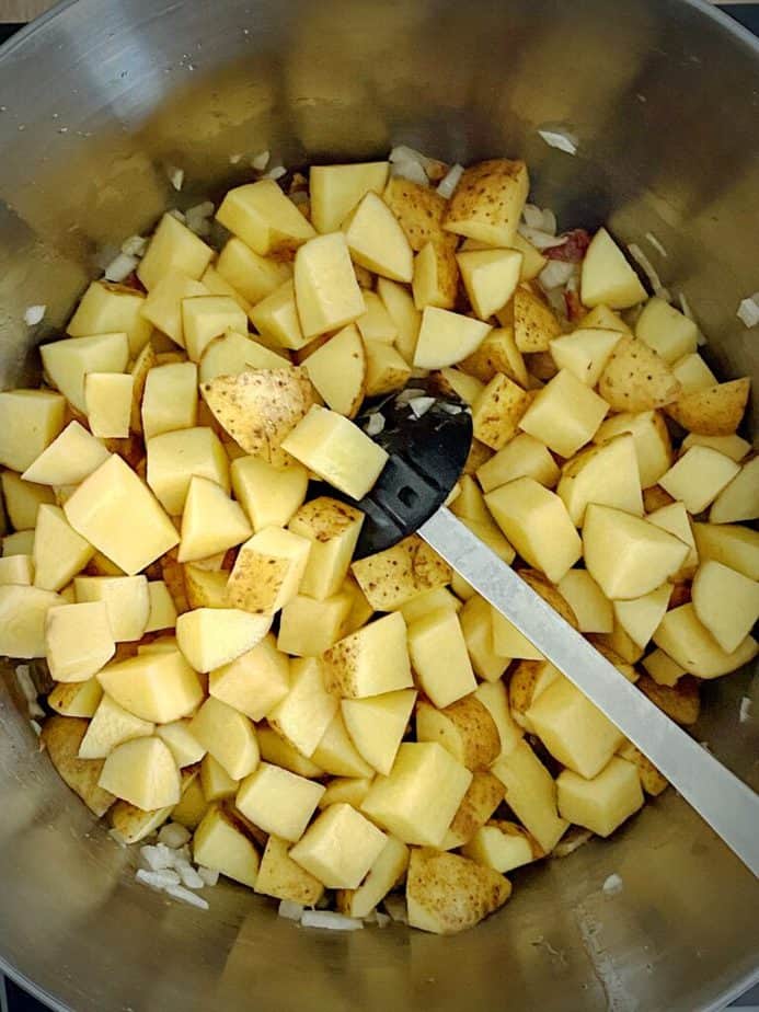 potatoes added to soup pan
