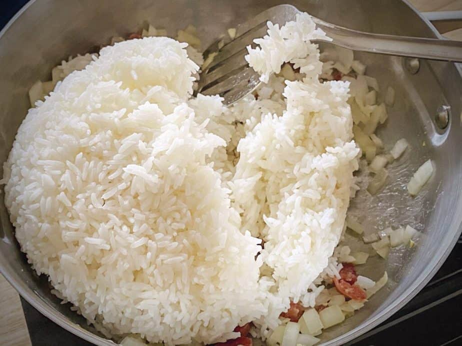cooked rice after being added to the Chinese sausage and onions