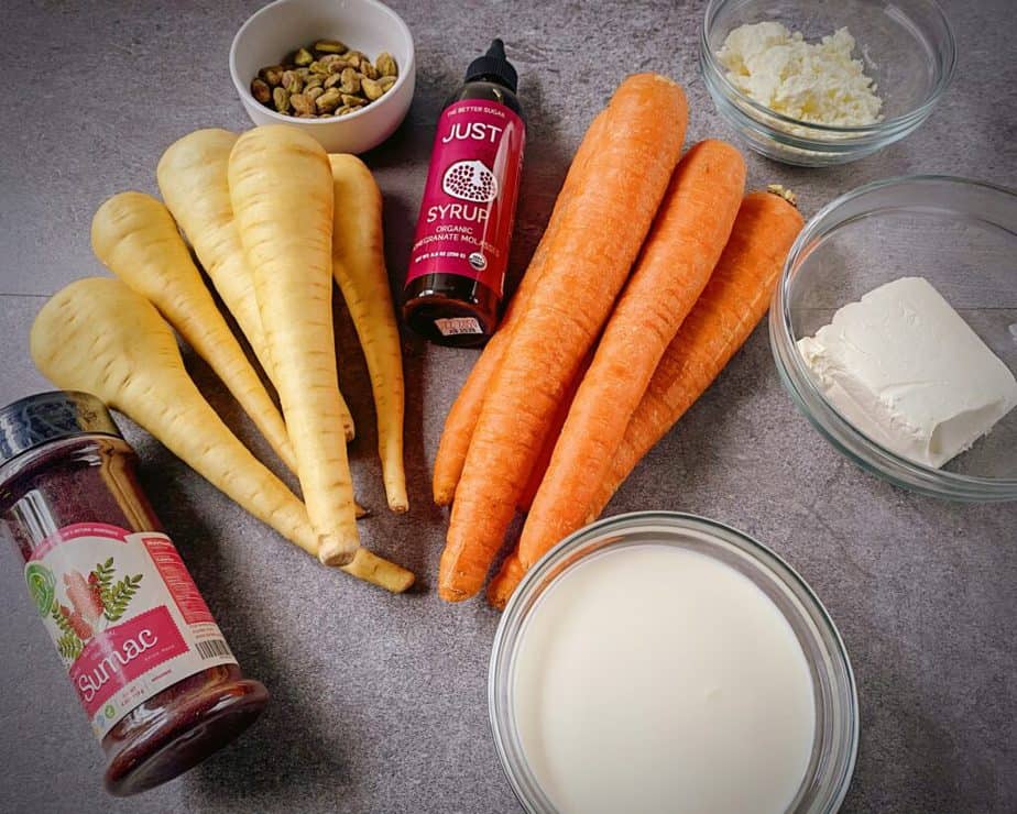 sumac powder, parsnips, carrots, pistachios, pomegranate molasses, feta, cream cheese and heavy whipping cream as mise en place for roasted carrots recipe