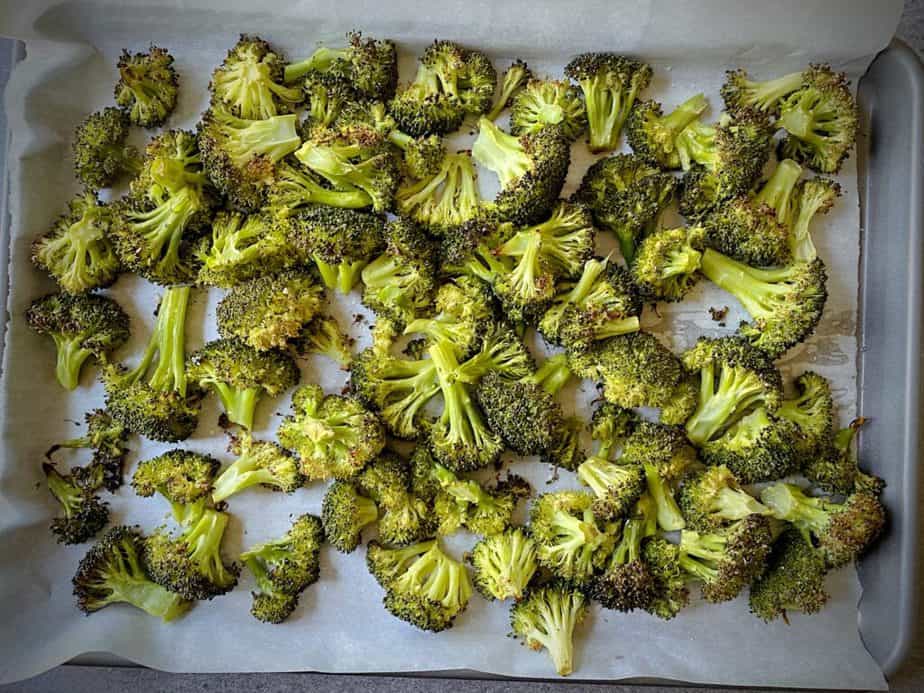 overhead shot of roasted broccoli on a parchment lined sheet pan