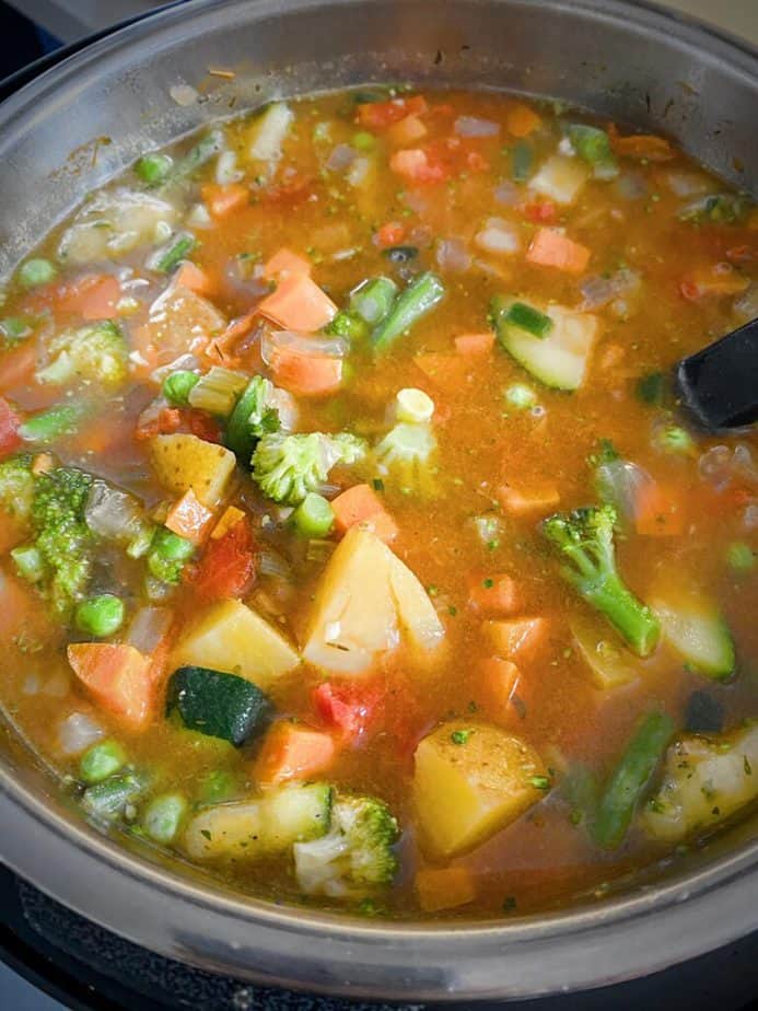finished instant pot veggie soup after frozen vegetables have been stirred in and warmed up