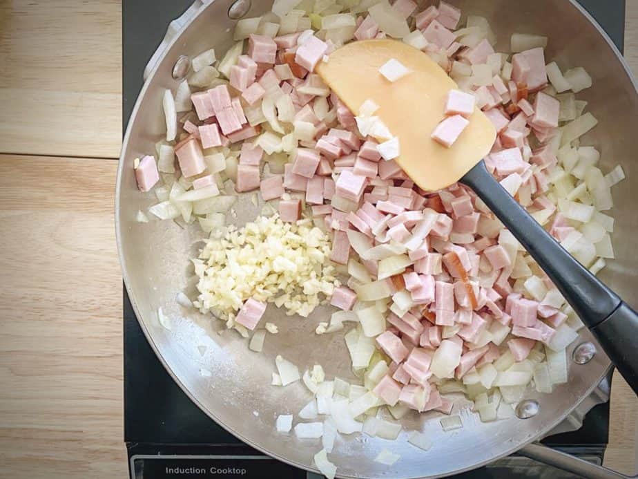 cubed ham and garlic added to skillet with onions