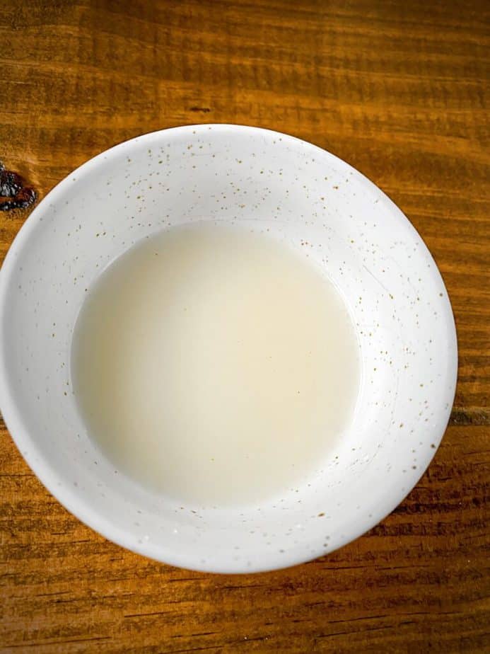 small white bowl with cornstarch, vinegar slurry