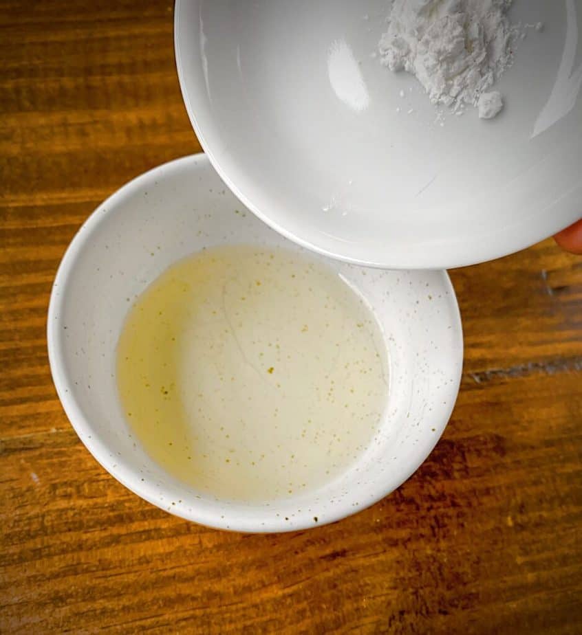 cornstarch being tipped into bowl with rice vinegar
