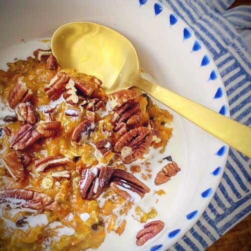 bowl of carrot cake oatmeal with a gold spoon