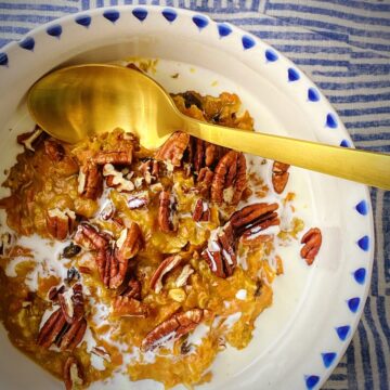 bowl of carrot cake oatmeal with a gold spoon.