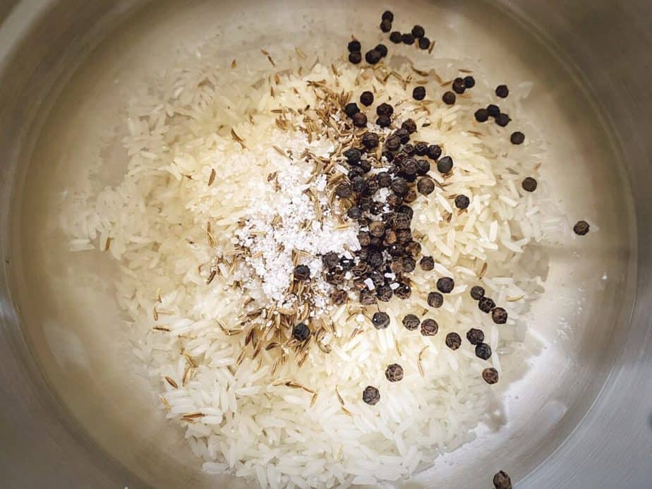 water, rinsed jasmine rice, salt, cumin seeds and peppercorns in a saucepan