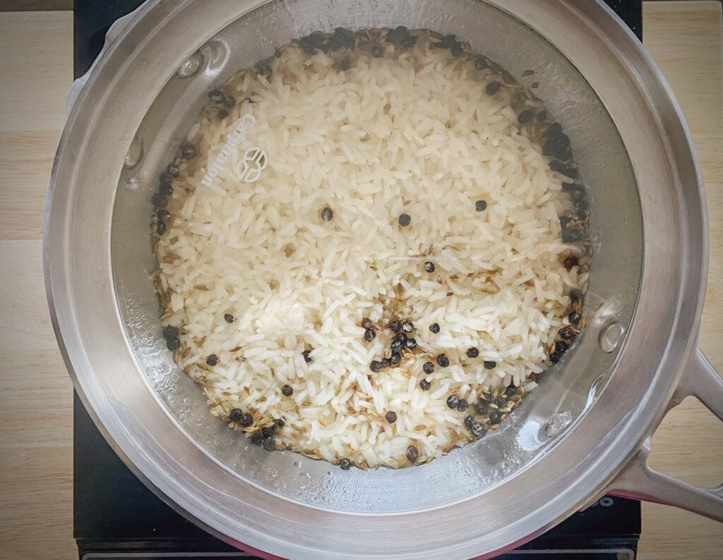 finished cumin rice in saucepan with lid