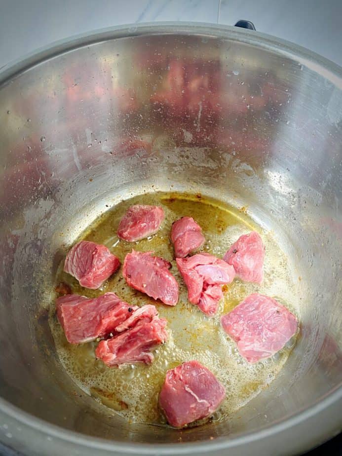 beef cubes added to bacon fat in bottom of instant pot