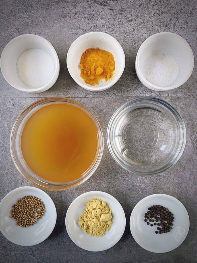 mise en place for turmeric pickled eggs brine - salt, turmeric, whole peppercorn, sugar, coriander seed, mustard powder, ACV, water