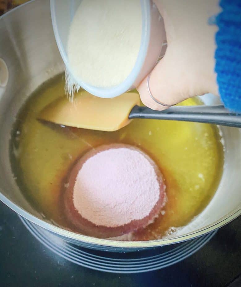 plain gelatin being added to saucepan with jello, cbd oil and water