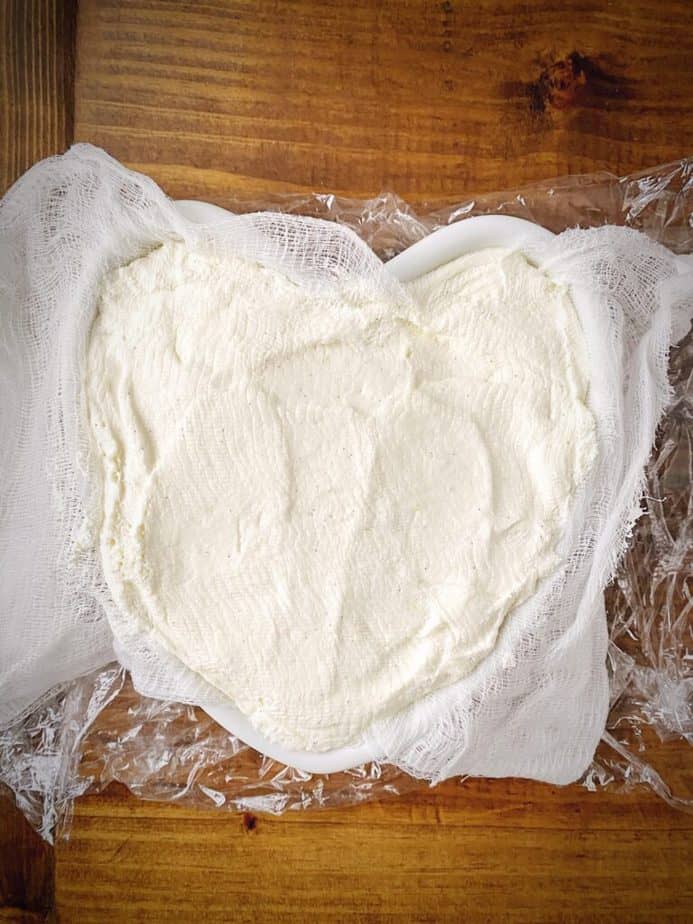 refrigerated coeur a la creme that has been unwrapped from plastic and top cheesecloth for plating