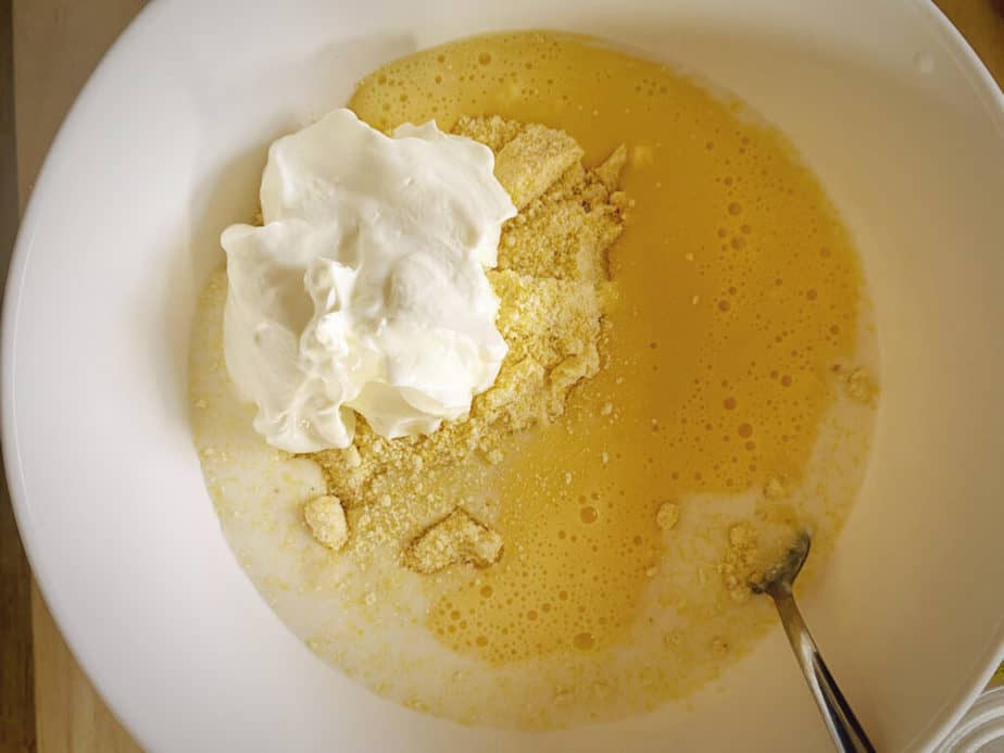 egg, buttermilk, greek yogurt and jiffy corn muffin mix in a bowl
