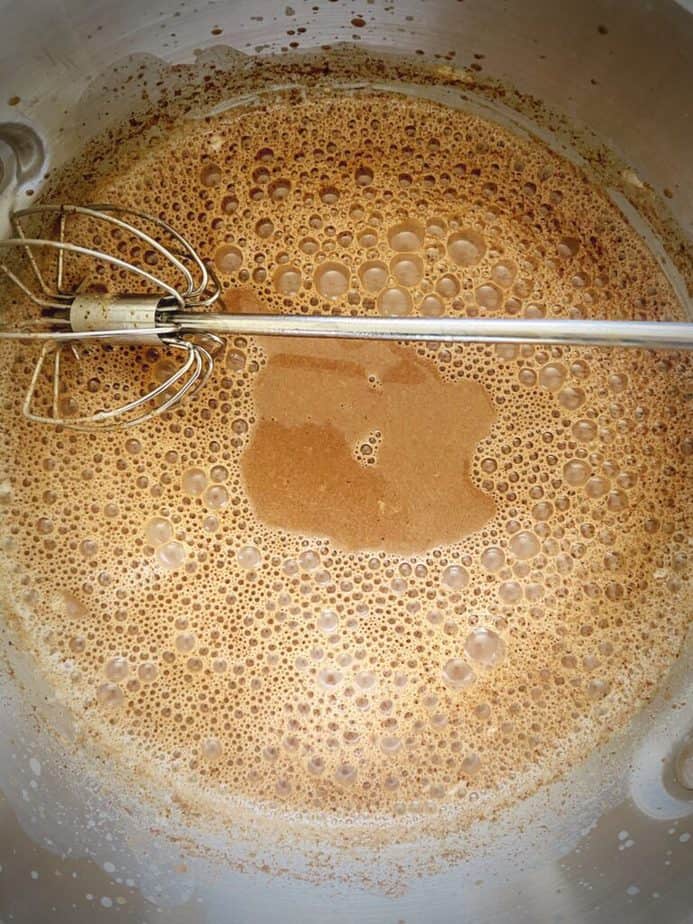 overhead shot of frothy spicy aztec sipping chocolate after mixing 