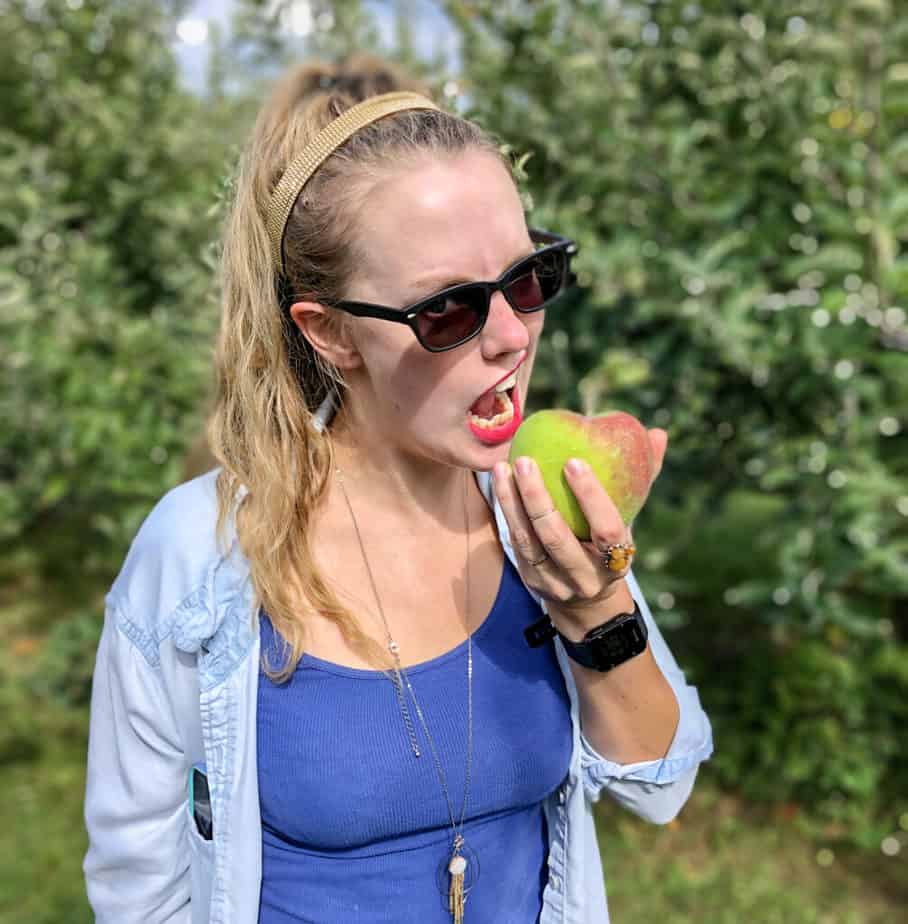Ash the addict chomping on an apple in the orchard