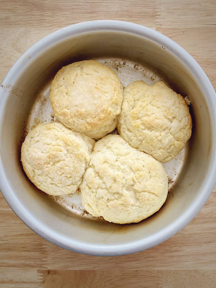 4 baked biscuit style shortcakes in a silver cake tin