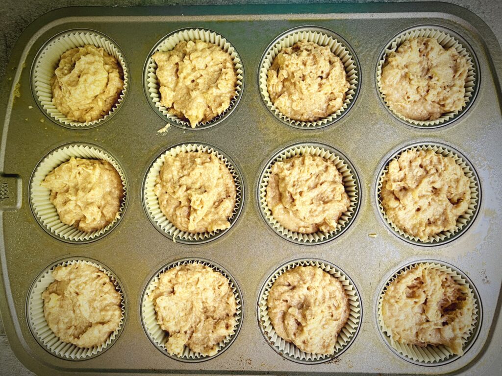 whole wheat banana muffin batter dished out into muffin cups