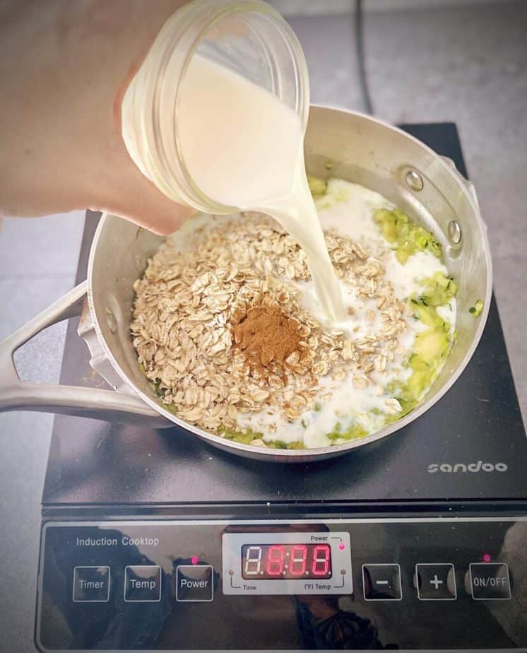 milk being added to zucchini oat saucepan
