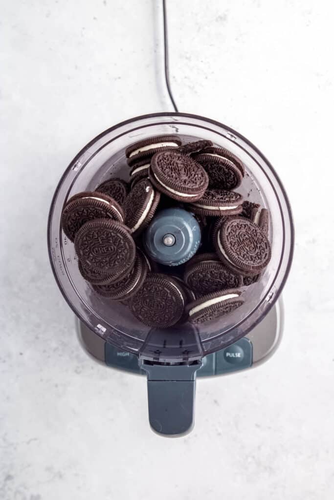 process step — whole oreos added to the base of a food processor.