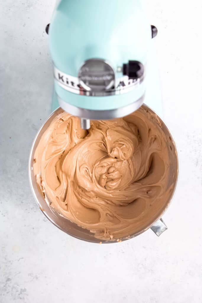 process shot - completed cream cheese peanut butter mousse in the base of a kitchenaid mixer.