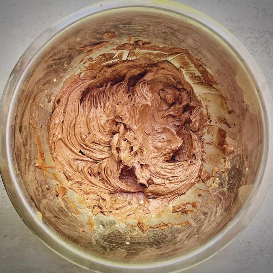overhead shot of completed bowl of chocolate peanut butter buttercream frosting