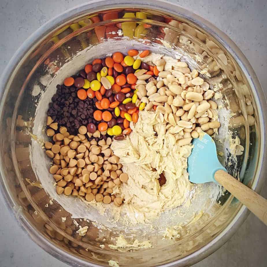 peanut butter chunks, chocolate chips, roasted peanuts and reeses pieces added to bowl