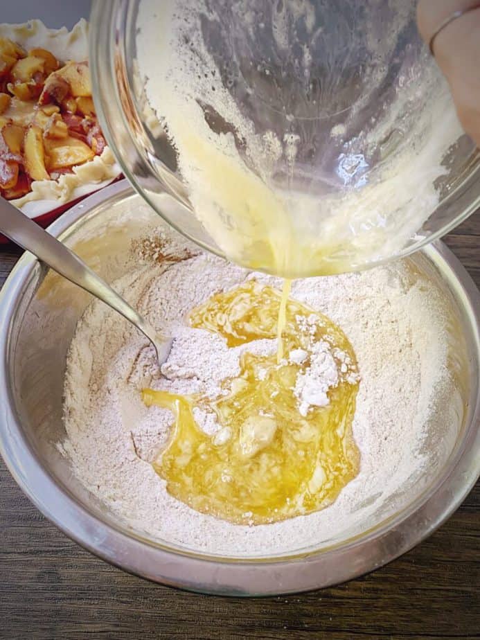melted butter being poured into dry ingredients