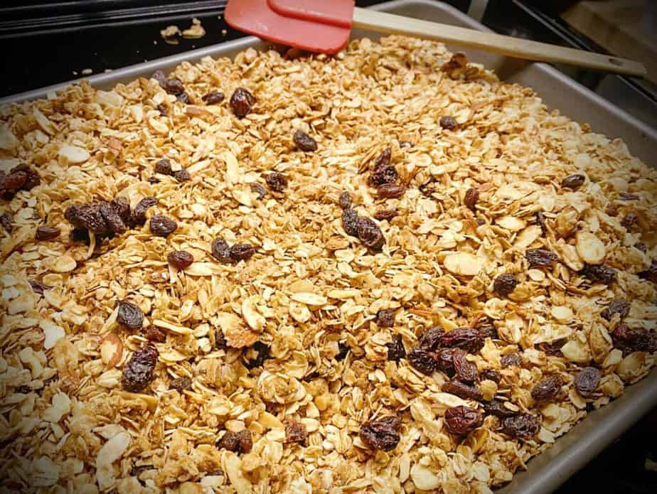 half of big batch baked granola on a sheet pan atop the oven